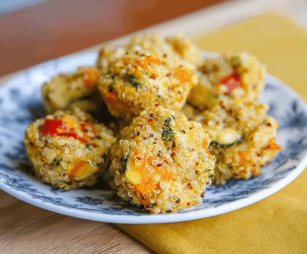 Delicious Quinoa Veggie Bites on a plate, perfect healthy appetizer or snack recipe with colorful vegetables and crispy exterior