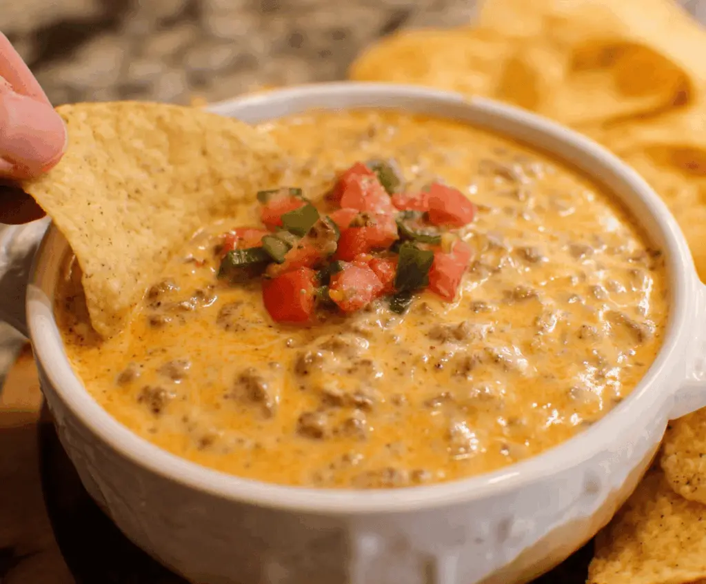 Creamy Rotel Dip with melted cheese, diced tomatoes, and green chilies in a serving bowl.
