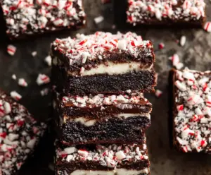 Rich and fudgy peppermint brownies topped with crushed peppermint candies and chocolate drizzle.