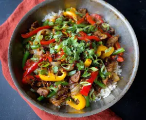 Delicious garlic pork stir fry with colorful vegetables served in a bowl