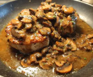 Delicious pork chops served with rich mushroom and shallot gravy, perfect for a hearty meal.